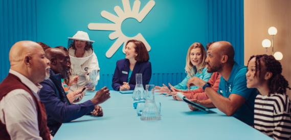 various people gathering around the table