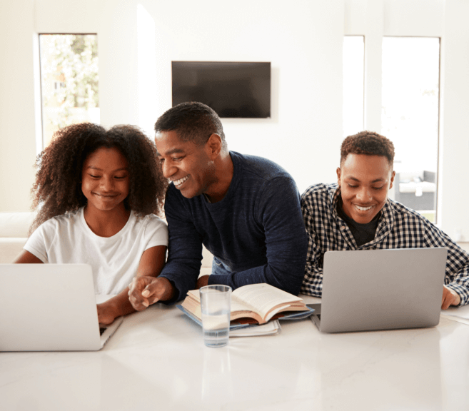 Family on laptops doing homeowrk