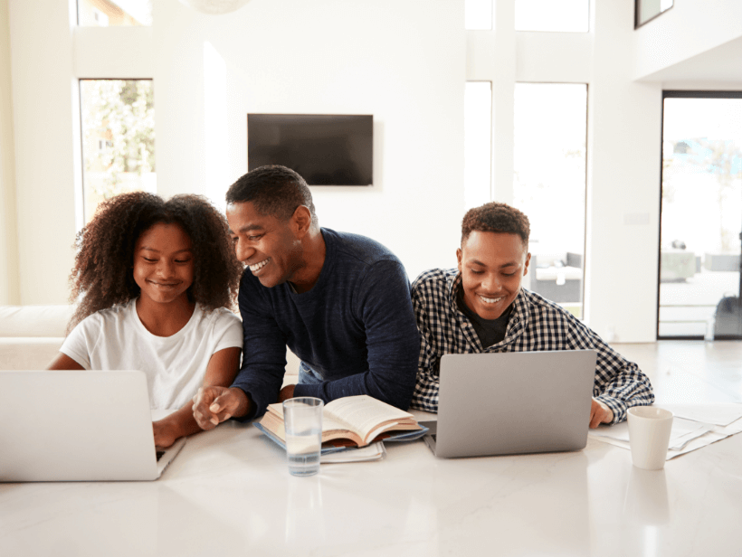 Father, daughter and son using their laptops to work.