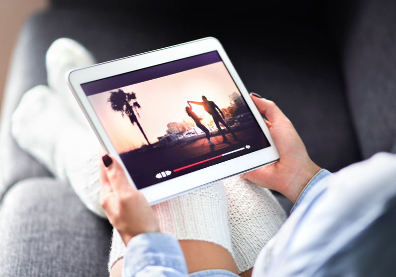 woman on phone in front of laptop