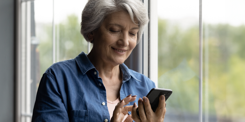 Senior aged female using smart phone